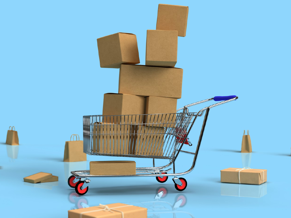 Carrinho de compras com caixas de papel kraft empilhadas, cercado por diversas embalagens menores, sobre fundo azul claro.